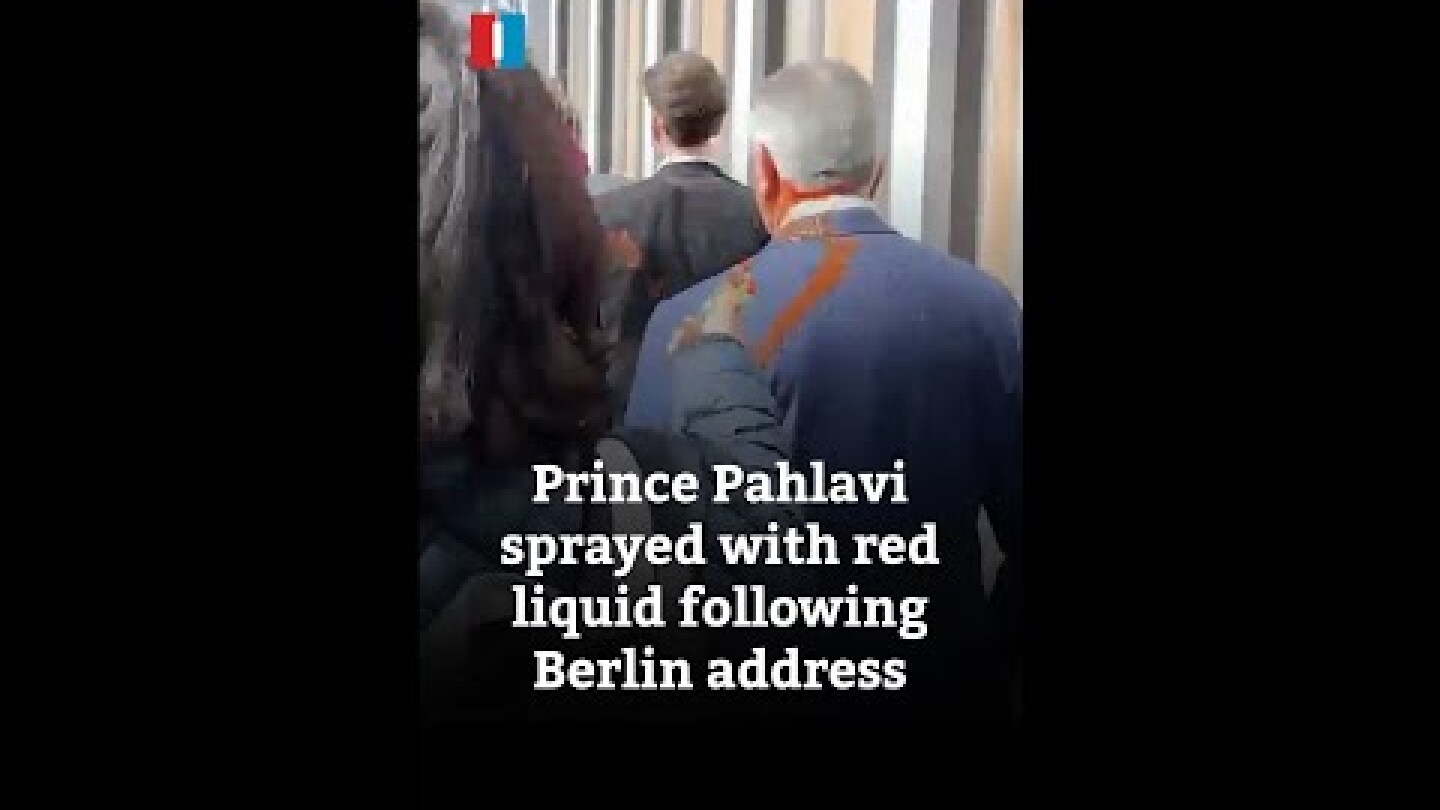 Prince Pahlavi sprayed with red liquid following Berlin address
