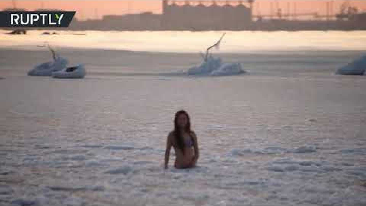 Bra-cing temperatures: Bikini-clad young woman plunges into icy waters of Caspian sea