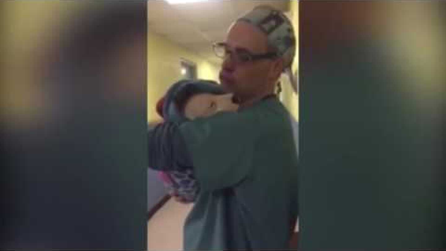 Vet comforts crying puppy after surgery