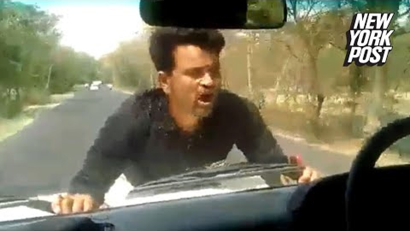 Pissed-off protester jumps on the hood of a politician's car | New York Post