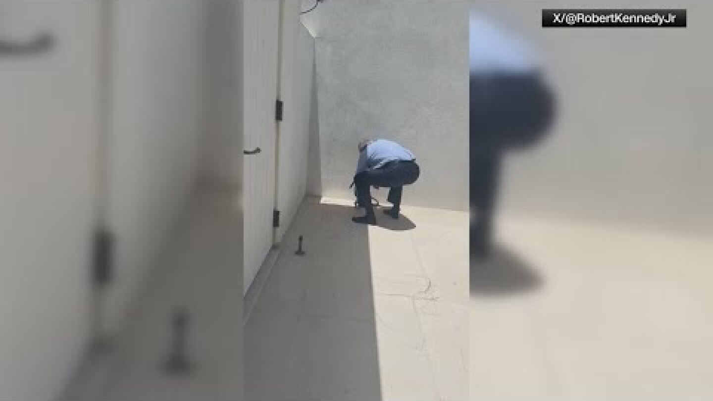 HHS Secretary Robert F. Kennedy Jr. picks up two snakes with bare hands