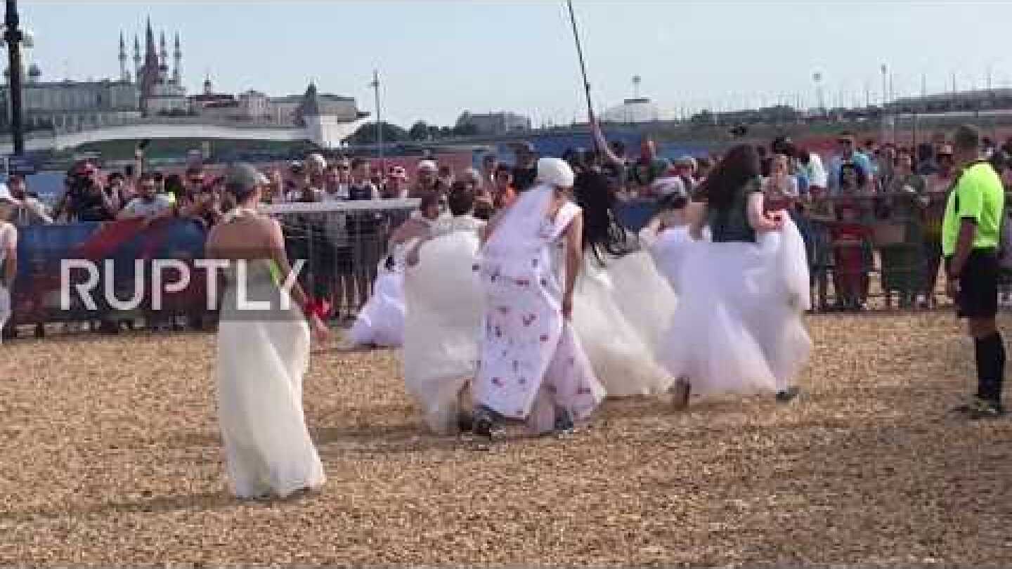 Playing away? Russian brides play footy in wedding dresses for World Cup