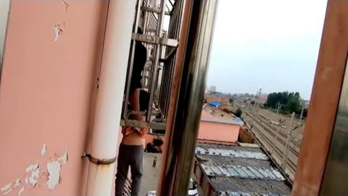 Firefighters rescue boy dangling from fourth floor window