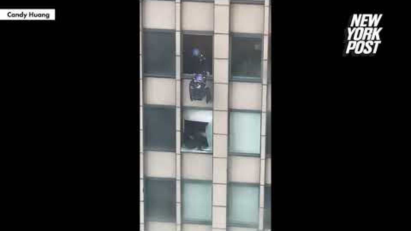 Video shows NYPD scale building to end 8-hour standoff with attempted jumper | New York Post