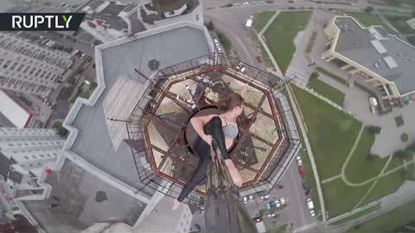 Extreme pole dancer shows skills on the roof of 16-storey building in Russia