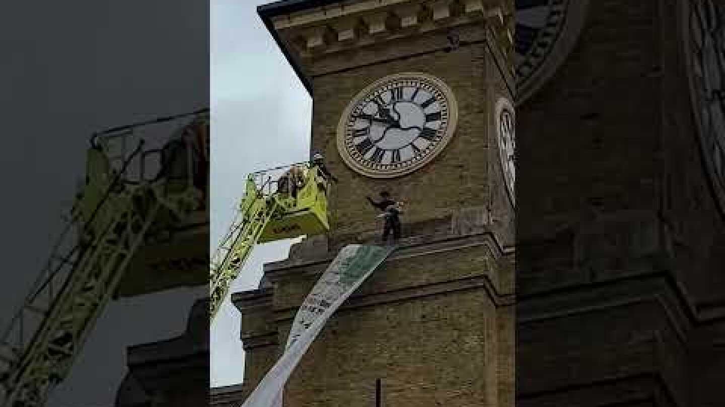 A protester clutching a dog climbed the clocktower at King’s Cross train station in London #shorts