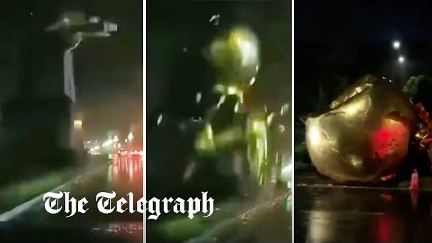 Flying horse statue narrowly misses driver when it topples over in storm