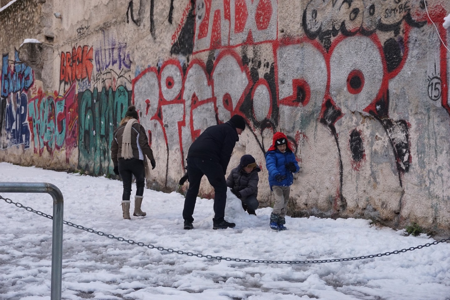 Μια οικογένεια φτιάχνει χιονάνθρωπο. 