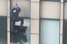Στιγμιότυπο από την επιχείρηση διάσωσης άνδρα που απειλούσε να πέσει από τον 31ο όροφο ουρανοξύστη στη Νέα Υόρκη