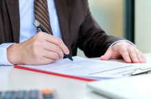 ανδρας συμπληρωνει αιτηση, στυλος