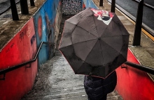 ανθρωπος με ομπρελα κατεβαινει σκαλες