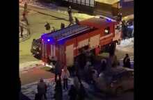 People drag cars out of the way of firetruck responding to emergency