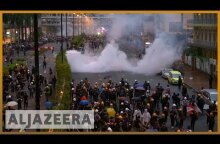 Hong Kong police draw guns, use water cannon in clashes