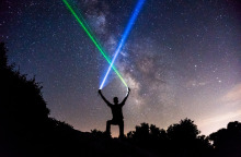 man-wielding-blue-and-green-lightsabers-in-the-starry-night-sky.jpg