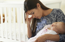 woman-with-postpartum-depression-holding-baby.jpg