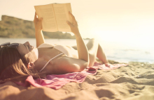 woman-lying-on-beach-reading-book.jpg