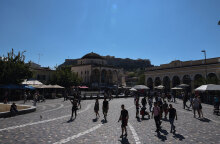 Κόσμος περπατά στην πλατεία στο Μοναστηράκι, με κάποιους να φορούν μάσκα για τον κορωνοϊό