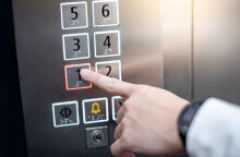 Άνδρας πατά το κουμπί σε ανελκυστήρα