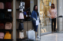 Click away και εμπορικά καταστήματα: Με μάσκα για τον κορωνοϊό και αντισηπτικό, πωλήτρια περιμένει σε ειδική θέση στην είσοδο τον καταναλωτή για την παράδοση του προϊόντος