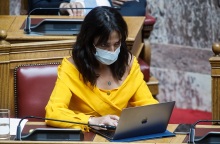 Η Δόμνα Μιχαηλίδου στα υπουργικά έδρανα της Βουλής με μάσκα και laptop
