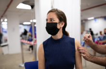 Woman receiving Covid-19 vaccine at a vaccination center/Getty Images/Ideal Image