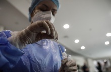 Γυναίκα κρατά στα χέρια της το υγρό και το στιλέο για rapid test