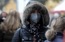 Γυναίκα με κουκούλα και κασκόλ προστατεύεται από το κρύο