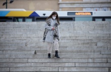Γυναίκα κατεβαίνει τα σκαλιά της πλατείας Συντάγματος φορώντας μάσκα προστασίας από τον κορωνοϊό