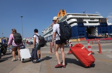 Ταξιδιώτες με τις βαλίτσες στο χέρι στο λιμάνι του Πειραιά