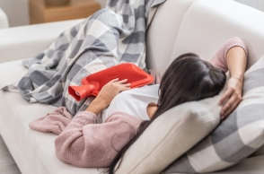 γυναικα ξαπλωμενη, καναπες, κουβερτα, κοκκινη θερμοφορα