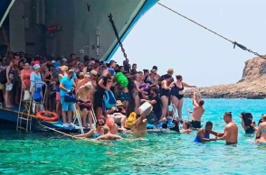 τουριστες βγαινουν απο πλοιο μεσα στο νερο