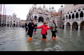 Woman's Luggage Floats Along Flooded Streets of Venice