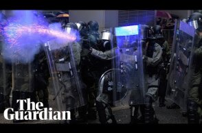 Police draw guns and deploy water cannon in clashes with Hong Kong protesters