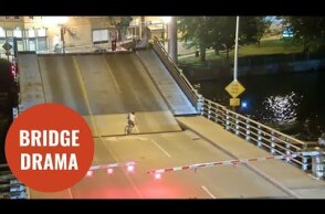 Cyclist ignores bridge warning barriers and falls into gap of drawbridge