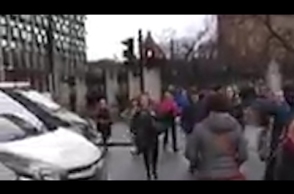 People flee parliament as gunshots ring out – video