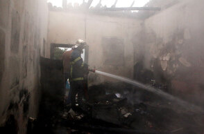 Πυροσβέστης σβήνει φωτιά σε κατοικία