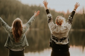 Δύο κορίτσια μπροστά από μια λίμνη. 