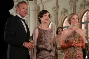 Downtown Abbey - Σκηνή από την ταινία όπου άνδρας και γυναίκες που κρατούν ποτά 