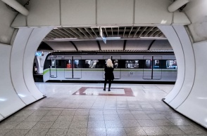 Γυναίκα σε σταθμό του μετρό και πίσω της ένας συρμός