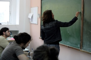 Καθηγήτρια γράφει σε πίνακα και από κάτω την παρακολουθούν μαθητές