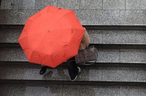 Γυναίκα με ομπρέλα εν μέσω καταιγίδας