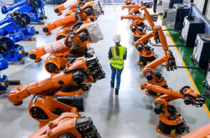 Ρομπότ και εργαζόμενη σε μια βιομηχανική μονάδα