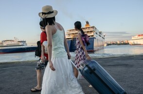 Επιβάτες στο λιμάνι του Πειραιά ετοιμάζονται να επιβιβαστούν σε πλοίο της γραμμής για νησιά του Αιγαίου