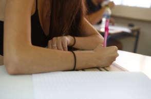 Υποψήφια των Πανελληνίων 2025 γράφει στο τετράδιο εξετάσεων