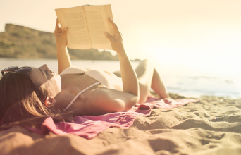 woman-lying-on-beach-reading-book.jpg