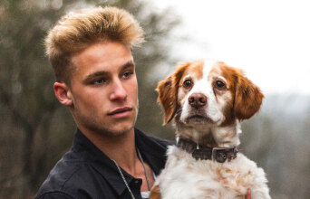 Άντρας που κρατάει σκύλο