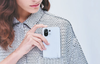 Γυναίκα βάζει κινητό στην τσέπη του πουκαμίσου της