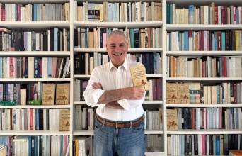 Ο Ξενοφών Μπρουτζάκης μπορστά από τη βιβλιοθήκη του