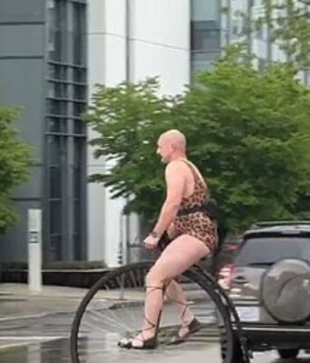 Σιάτλ σε άλλη διάσταση: Άνδρας με λεοπάρ κορμάκι έκανε βόλτα με βικτωριανό ποδήλατο μέσα στη βροχή