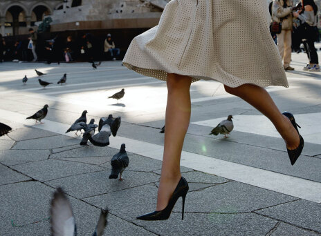 Γυναίκα περπατάει με τακούνια σε πλατεία